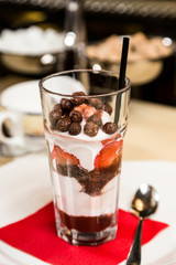 Restaurant serving dish - sweet dessert in glass on table