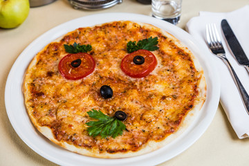 Restourant serving dish for child`s menu - pizza with face