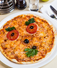 Restourant serving dish for child`s menu - pizza with face