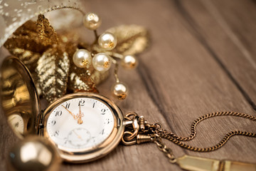 Vintage pocket clock showing five to twelve and golden decoratio