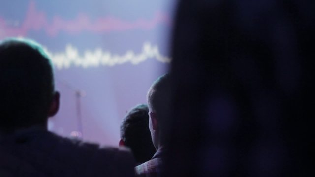 young guys dancing in a concert in a music club