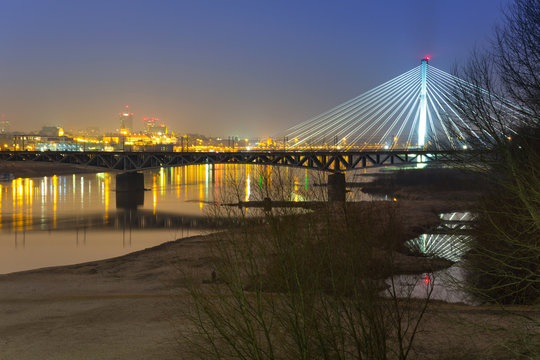 Panorama of Warsaw at night with reflection in Vistula river
