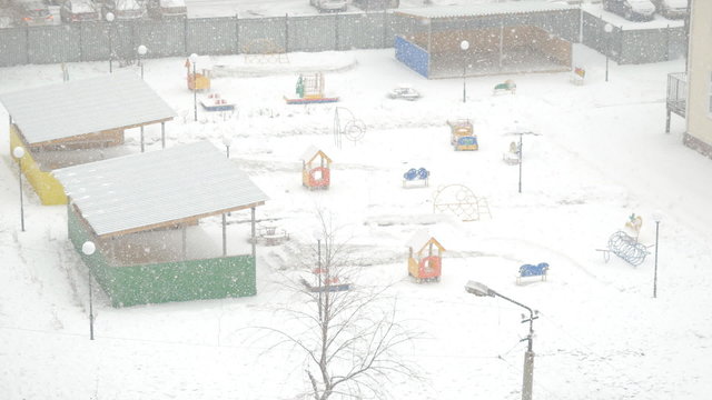 swirling flakes of snow on the playground