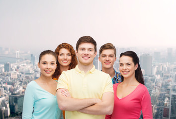 group of smiling teenagers over city background