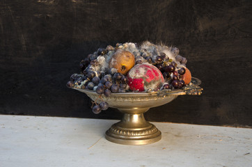 antique pedestal dish vase with various rotten fruits - 79641667