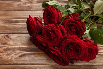 Red roses on wooden surface