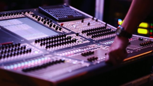 Audio Mixing Console with Audio Engineer in front during Show
