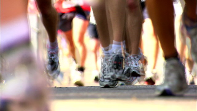 Close shot of feet in Marathon with shutter in