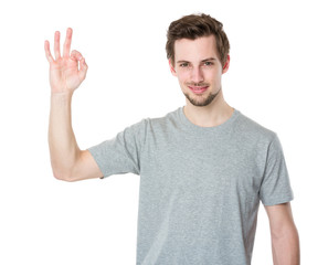 Young man gesturing okay sign