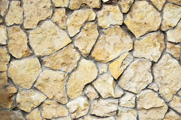 Yellow wild stone wall background