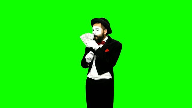 Funny man mime counts money and hides it on green screen
