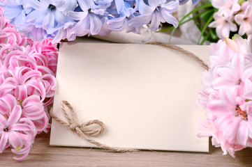 Spring frame surrounded by hyacinth flowers, text space