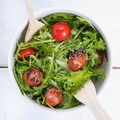 Mixed salad with arugula, cherry tomatoes and sesame seeds.