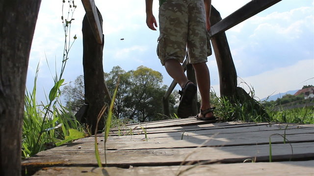 Passing A Wooden Footbridge