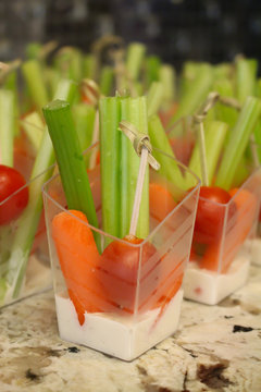 Vegetables and dipping sauce in individual cups