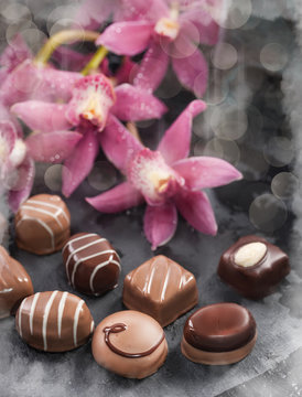 Chocolate pralines decorated with with orchids