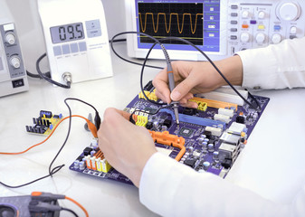 Tech tests electronic equipment