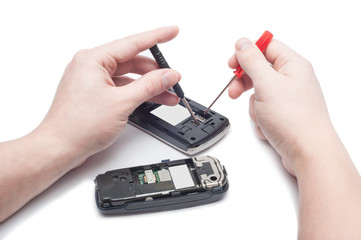Close-up Of Human Hand Repairing Cellphone With Screwdriver