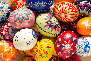 colorful easter eggs in wooden bowl