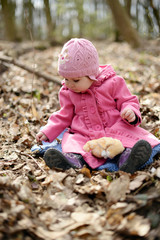 Little cute baby on a picnic in a spring forest