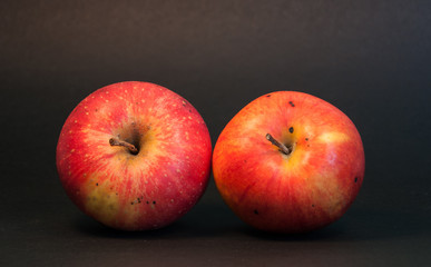 Two apples on black background