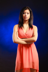 mixed race girl in party dress on blue