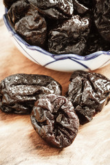 dried plums prunes on wooden table