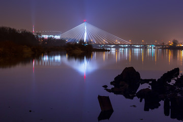 Naklejka na ściany i meble Panorama of Warsaw at night with reflection in Vistula river