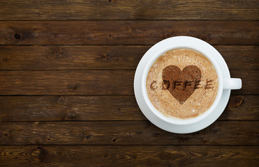 Cup of coffee with heart on the wood