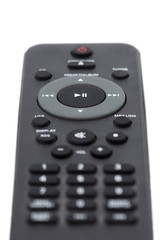 Closeup of a dark grey remote control, isolated on white