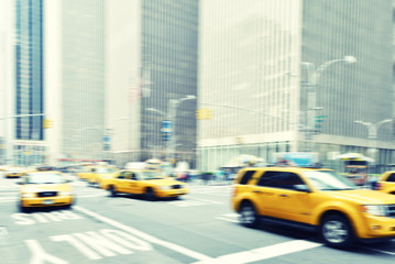 Blurred image of yellow taxis in the streets of  New York City