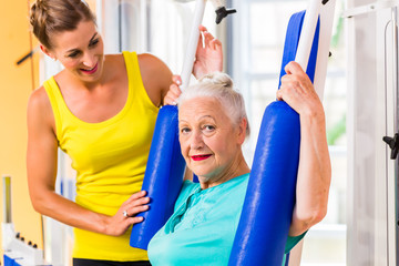 Senior woman doing fitness sport in gym or health club