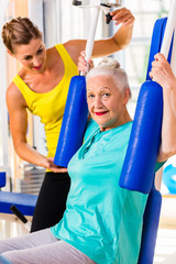 Senior woman doing fitness sport in gym or health club