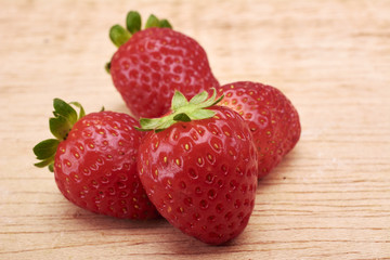Strawberries red in wood background