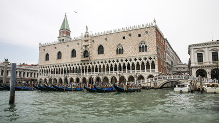 Gondolas parking near Doges palace in summer Venice