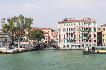 Fototapeta na wymiar Quay and bridge over channel in Venice