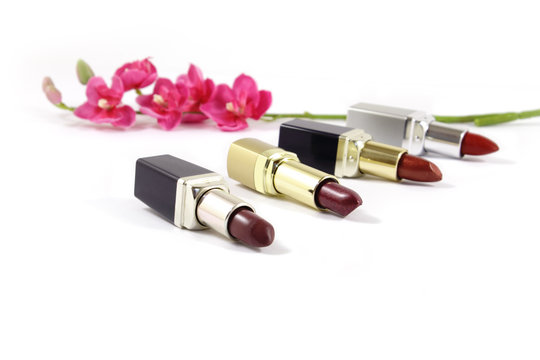 Lipsticks and flowers. Isolated