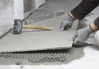 Home improvement, renovation - construction worker tiler is tili