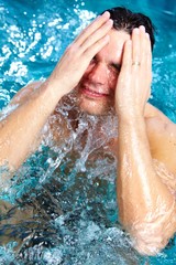 Man relaxing in jacuzzi.