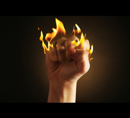 Burning fist isolated on black