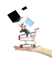 Goods falling into cart isolated on white