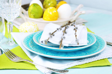Easter table setting on color wooden background