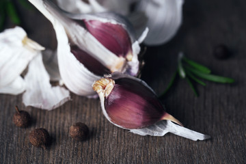 Raw garlic and spices on old wooden table