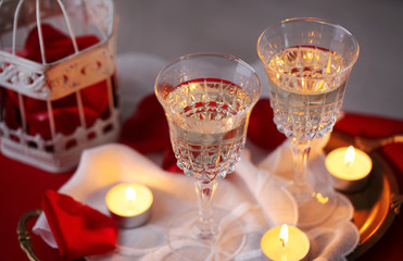 Champagne glasses and rose petals for celebrating Valentines