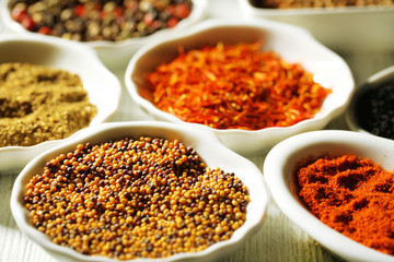 Different kinds of spices in ceramics spoons, close-up,