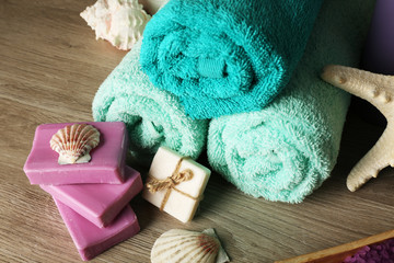 Obraz na płótnie Canvas Spa composition with towels and soap on wooden background