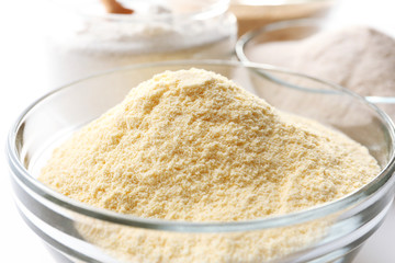 Different types of flour in bowls close up