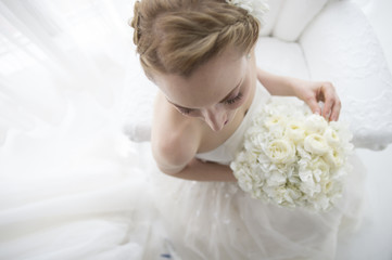 Obraz na płótnie Canvas Bride sitting wearing a wedding dress