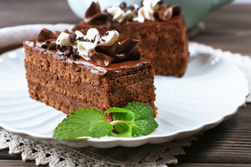 Tasty pieces of chocolate cake with mint