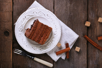 Tasty piece of chocolate with lump sugar and cinnamon sticks